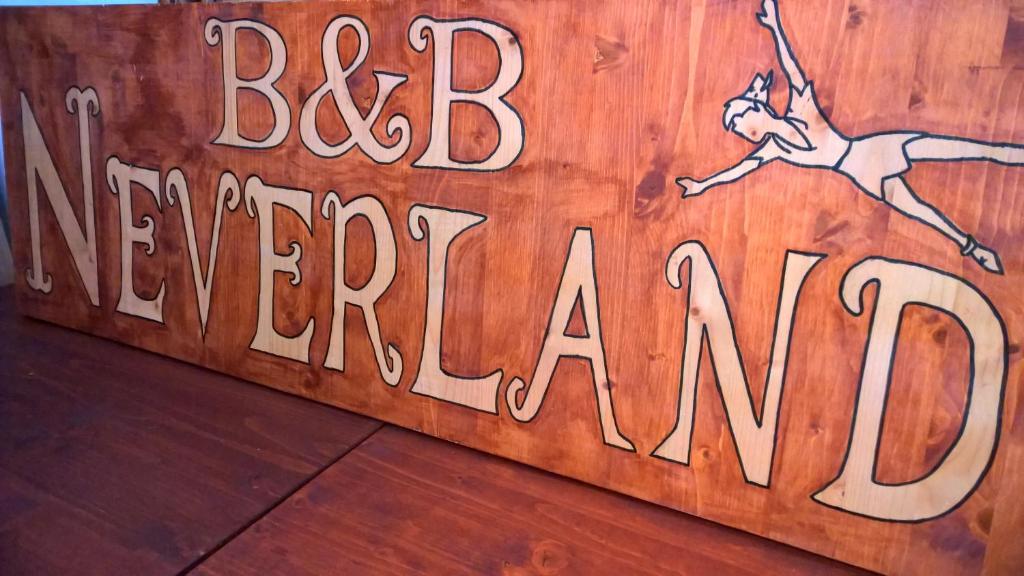 a sign that says big americanax on a wooden wall at B&B Neverland in Marrùbiu