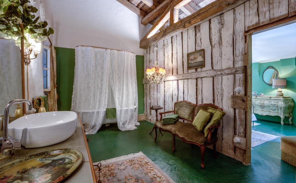 a bathroom with a sink and a chair in a room at Glamping Canonici di San Marco in Mirano