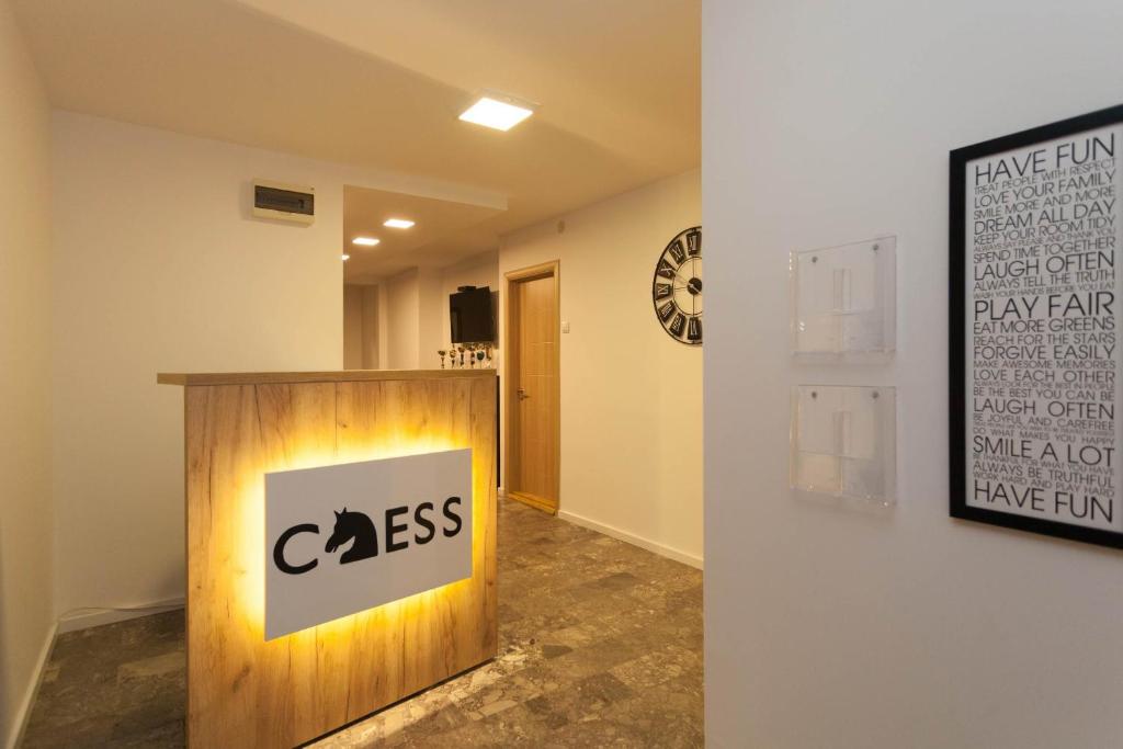 a room with a coss sign on a wall at Chess Apartments in Belgrade