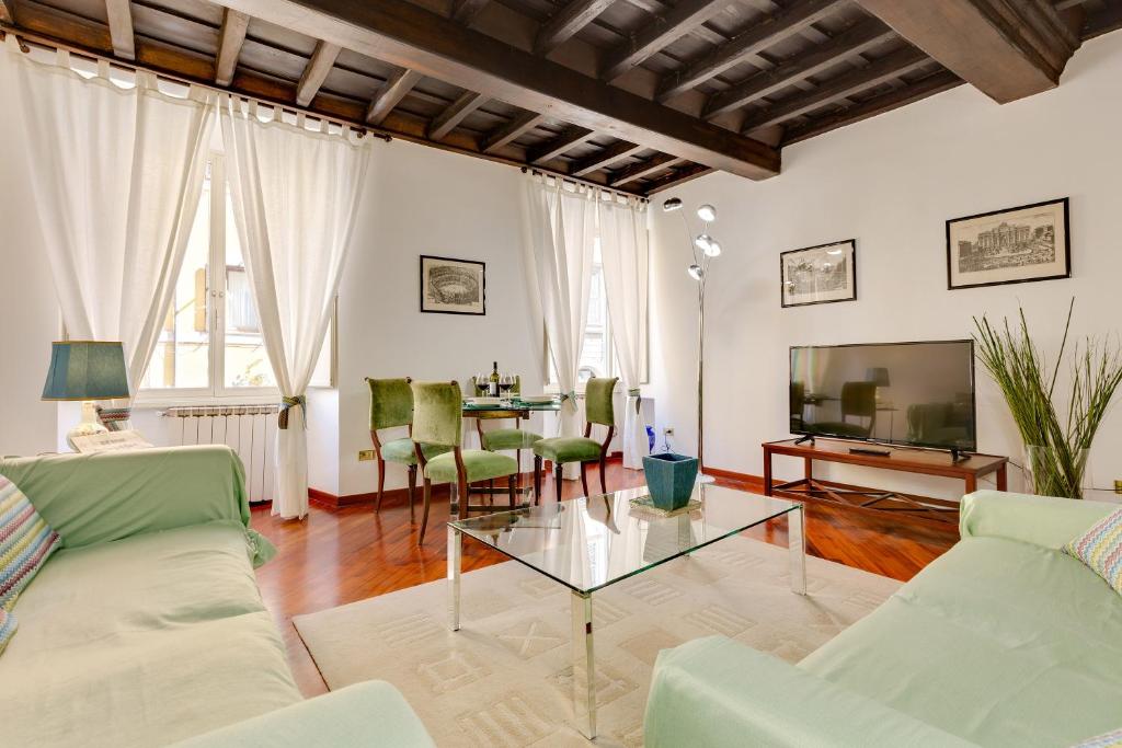 a living room with a couch and a table at Rome as you feel - Panisperna Apartment in Rome