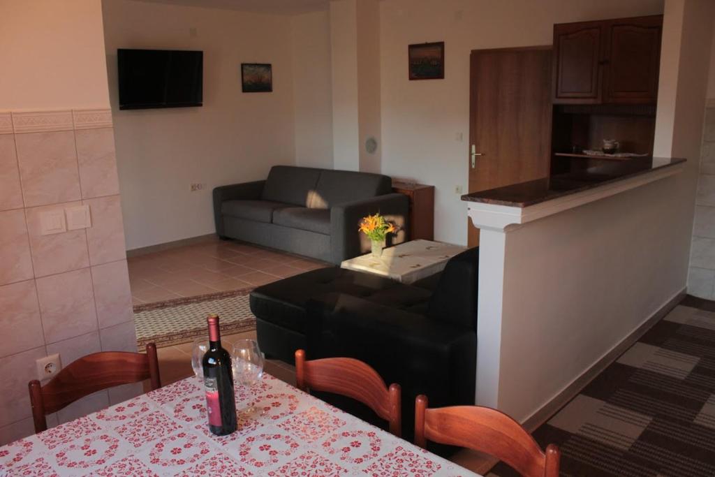 a living room with a table and a couch at Apartmani Peko in Pag