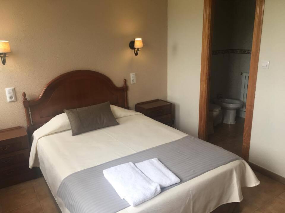Postel nebo postele na pokoji v ubytování Hostal El Paso