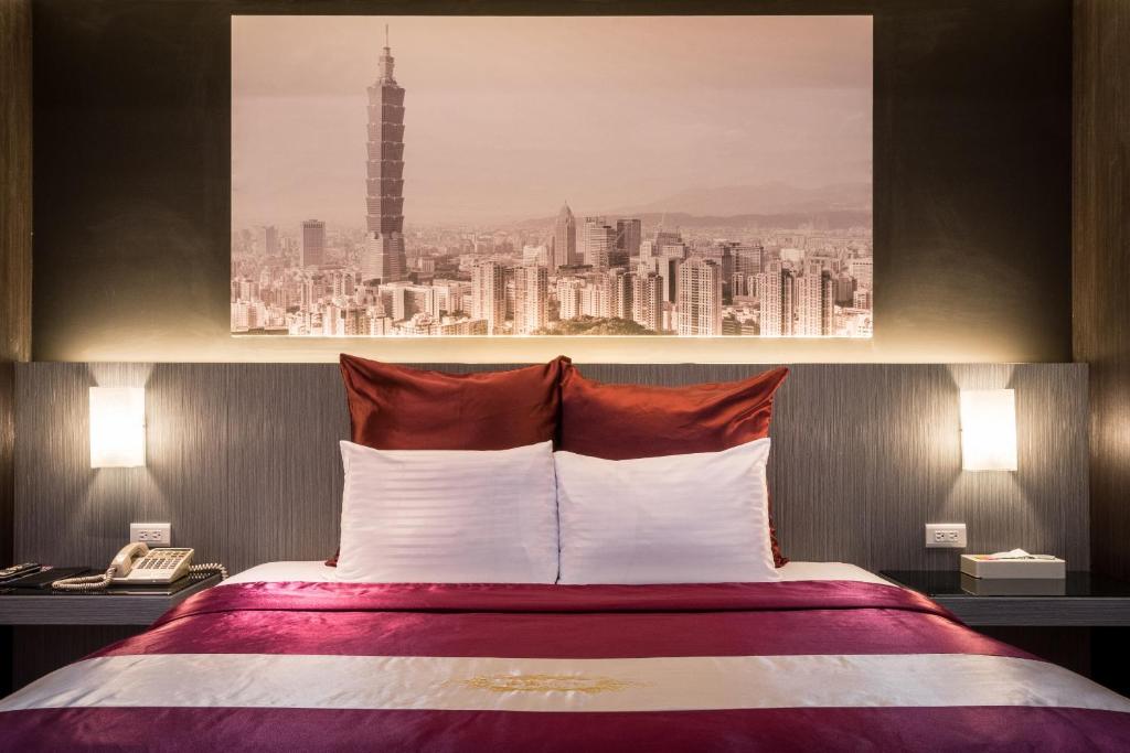 a hotel room with a bed with a view of a city at Ching Ching Motel in Sanxia