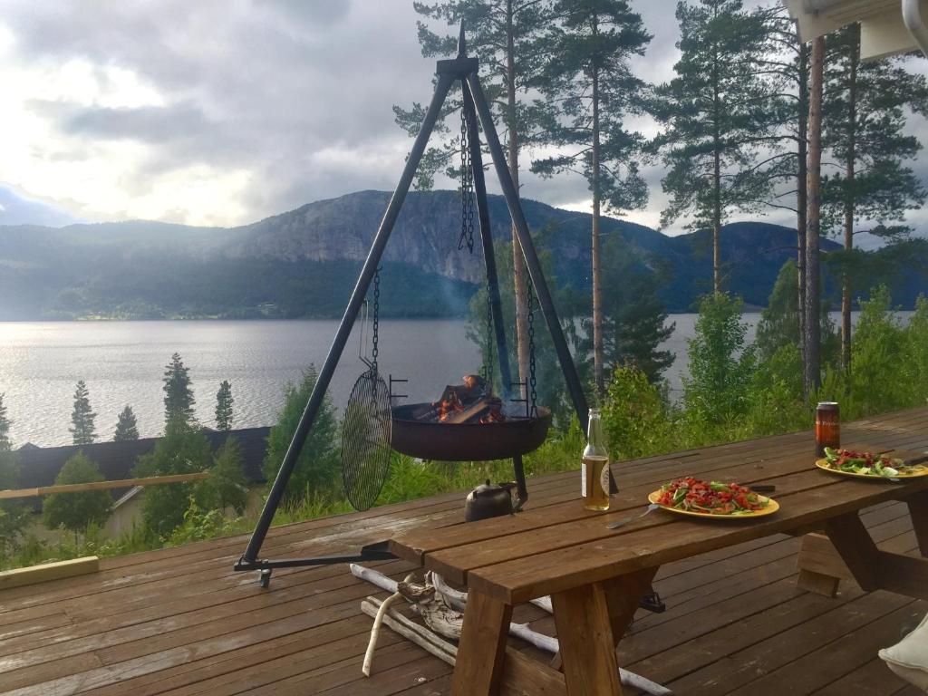 a dog is sitting in a swing on a deck at Apartment - Lille Galleri - Fyresdal in Fyresdal