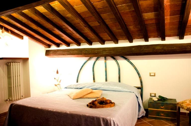 Łóżko lub łóżka w pokoju w obiekcie Agriturismo Podere dei kiwi