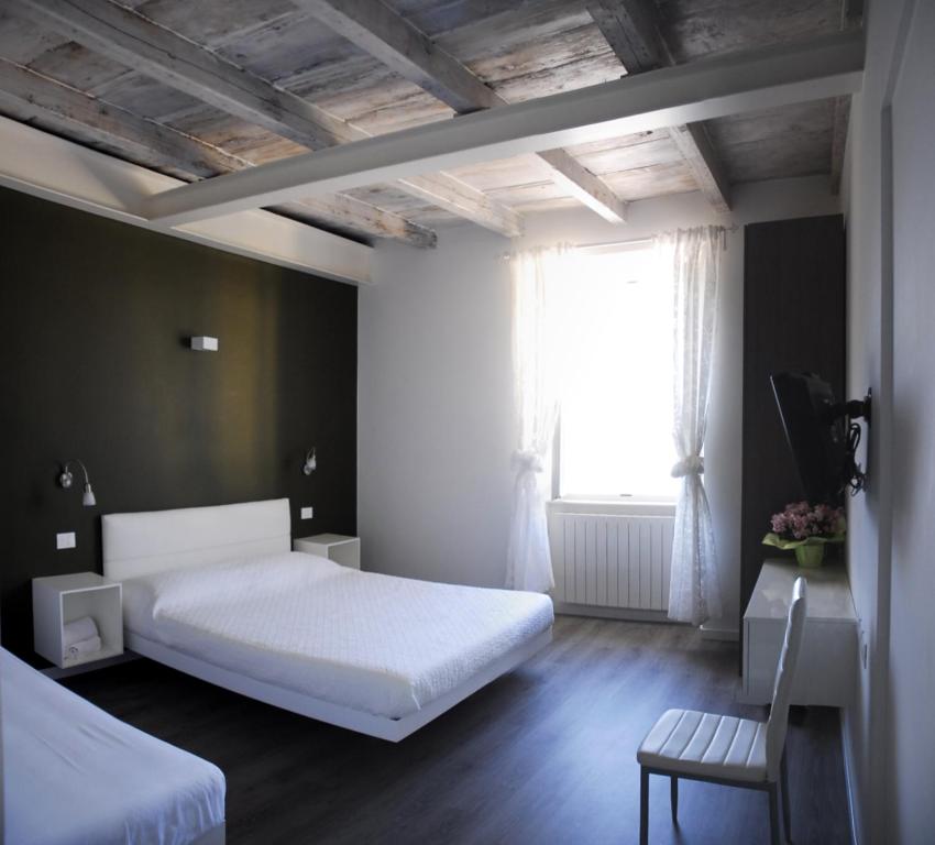 a bedroom with a white bed and a window at Iseo Lake in Castro