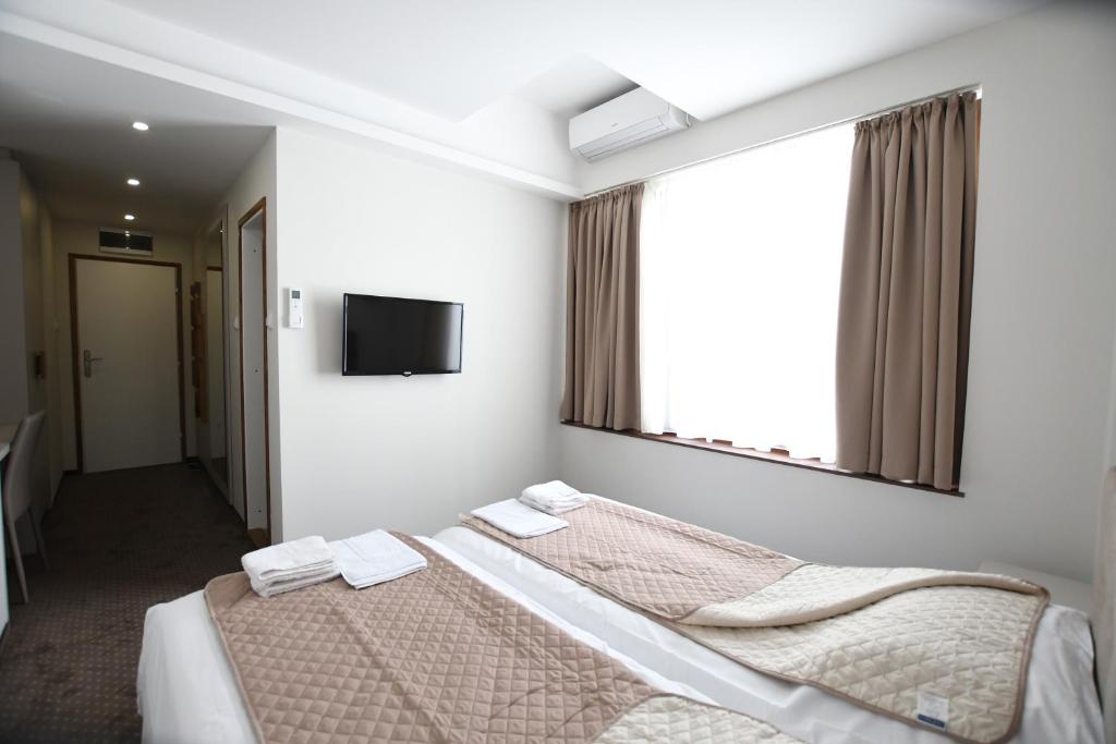 Postel nebo postele na pokoji v ubytování Atrijum Apartments and Rooms