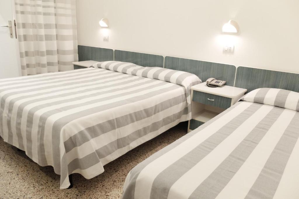 Postel nebo postele na pokoji v ubytování Hotel Aurea