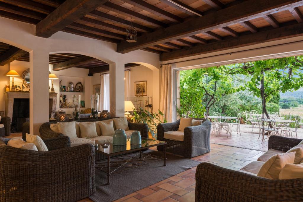 a living room with furniture and a large window at Saint-Vincent in Saint-Tropez