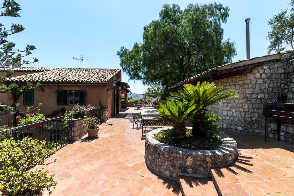 un patio con tavolo, sedie e un edificio di Sicily Home- Intera Villa a Favara