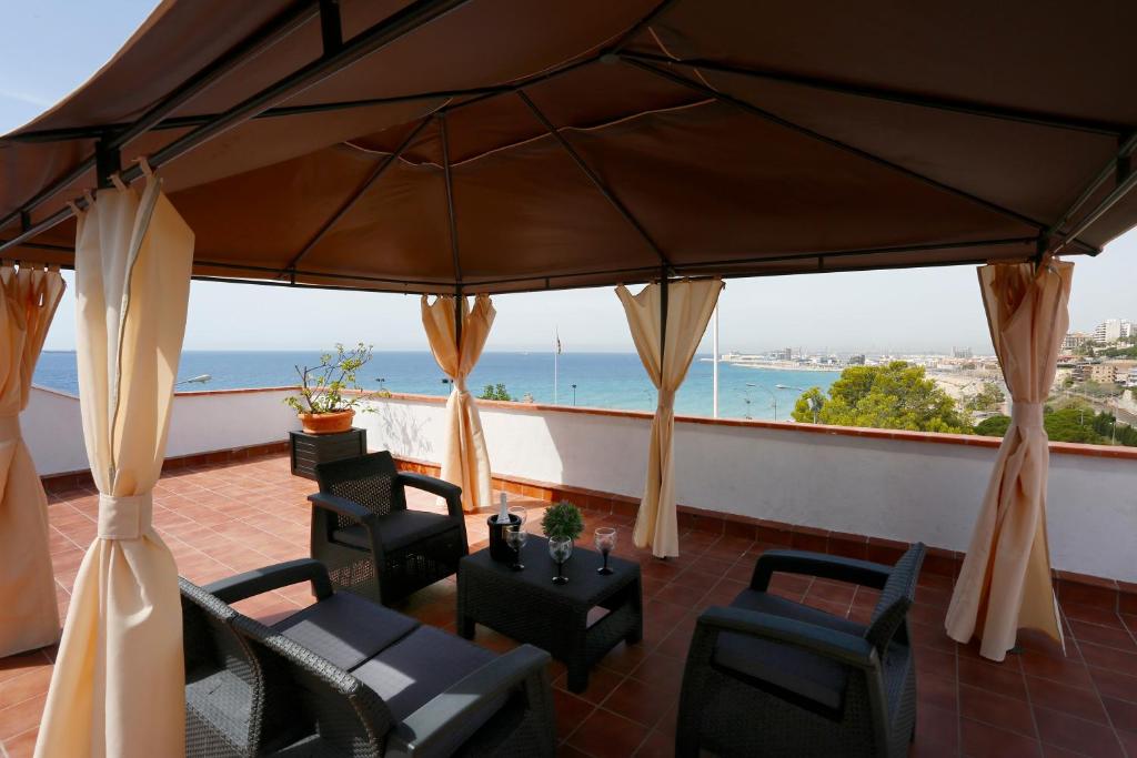 a balcony with chairs and a view of the ocean at Villa hortencia in Tarragona
