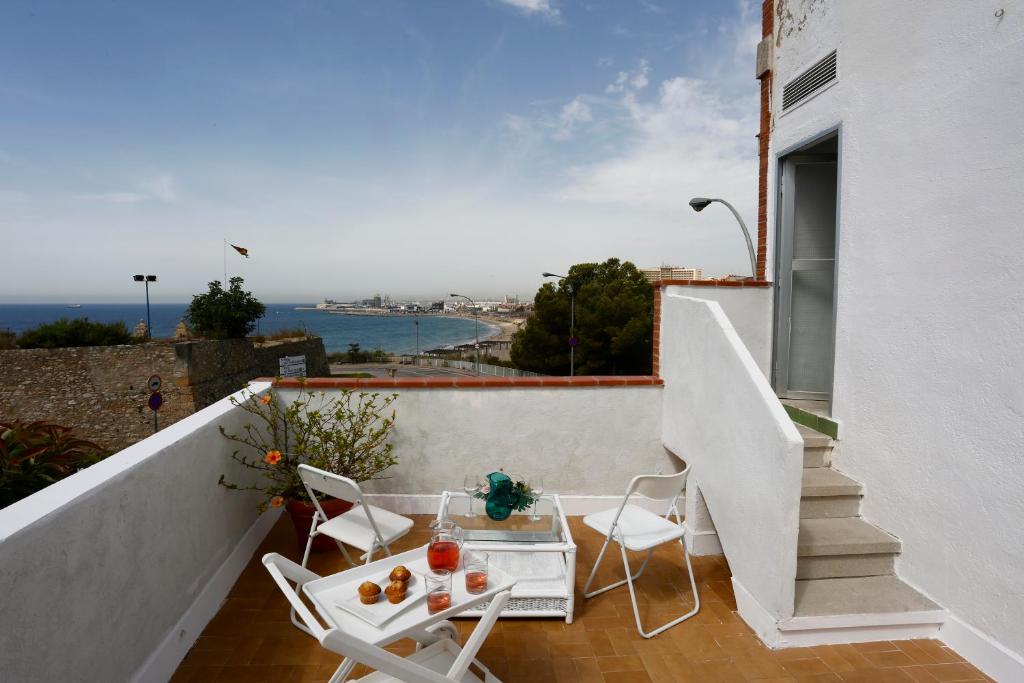 a balcony with a table and chairs on a building at Villa hortencia in Tarragona