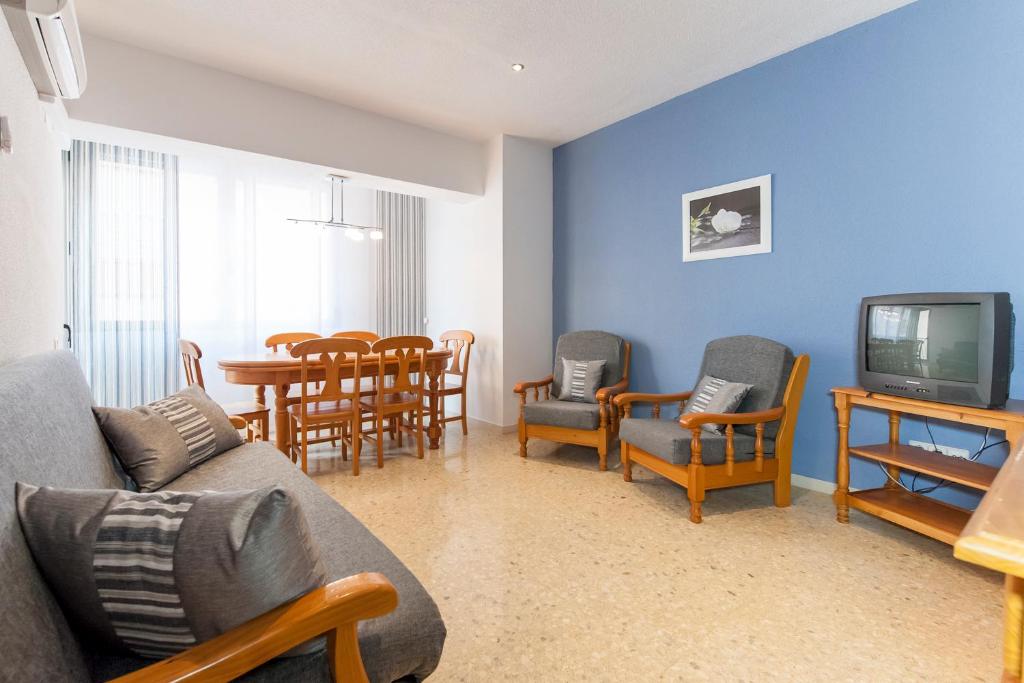 a living room with a couch and chairs and a tv at Prado in Peniscola
