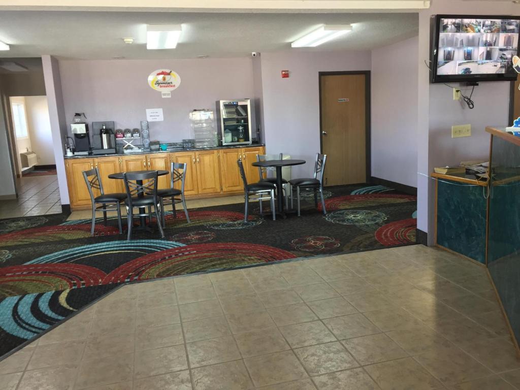 a restaurant with tables and chairs in a room at Super 8 by Wyndham Sweet Springs in Sweet Springs