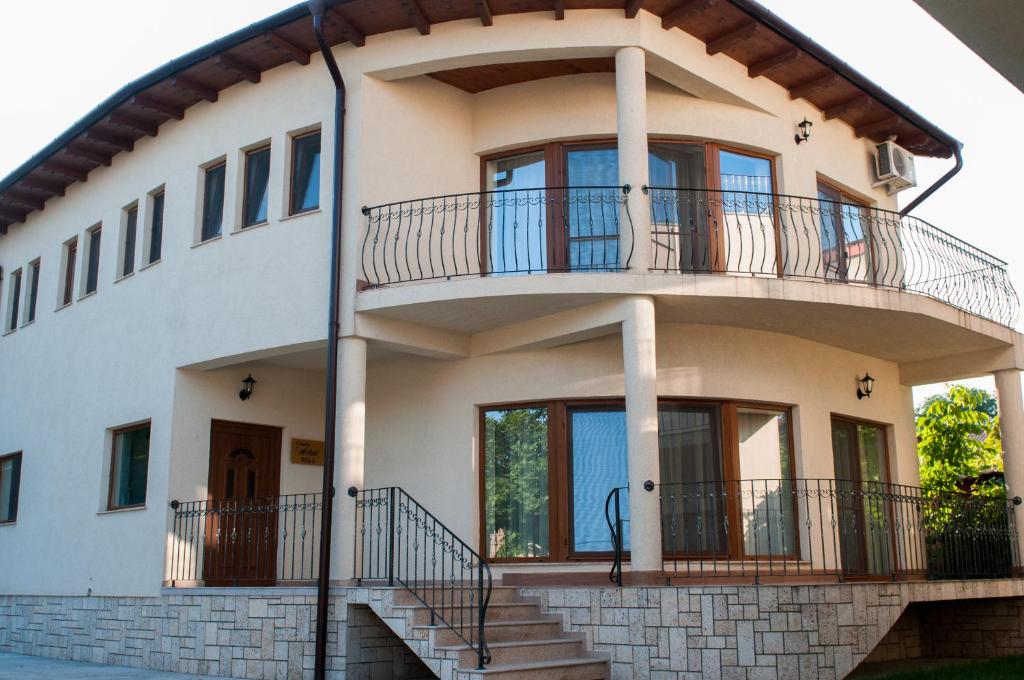 a large white house with a round balcony at Complex Adal in Eforie Nord