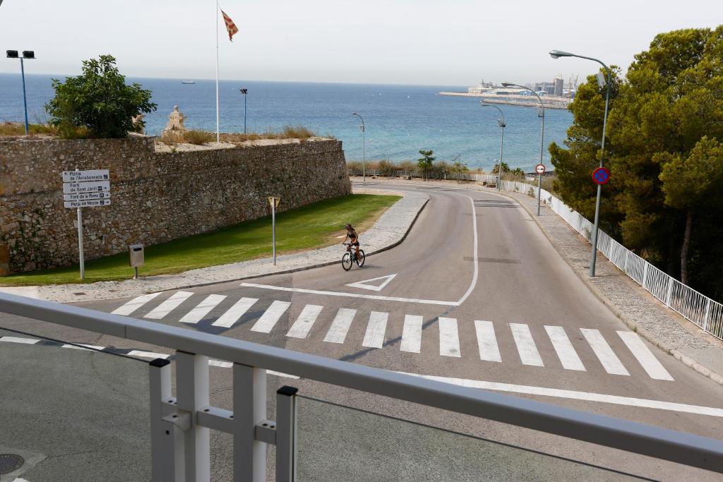 a person riding a bike down a road at Villa hortencia in Tarragona