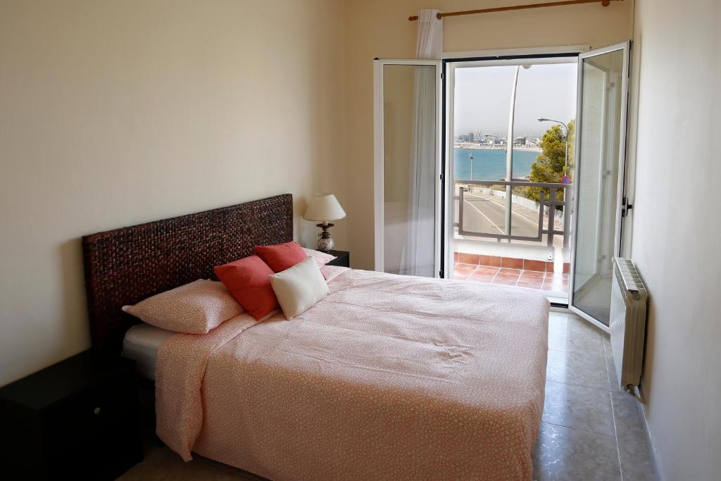 a bedroom with a bed with a view of the ocean at Villa hortencia in Tarragona