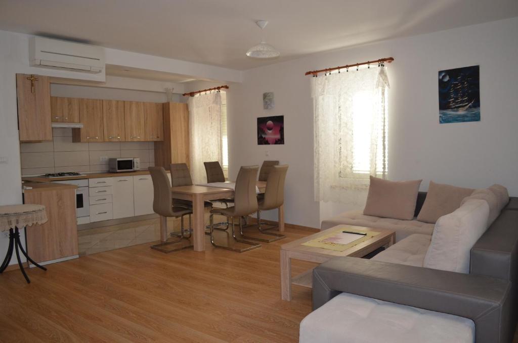 a living room and kitchen with a couch and a table at Apartment Michael in Krk