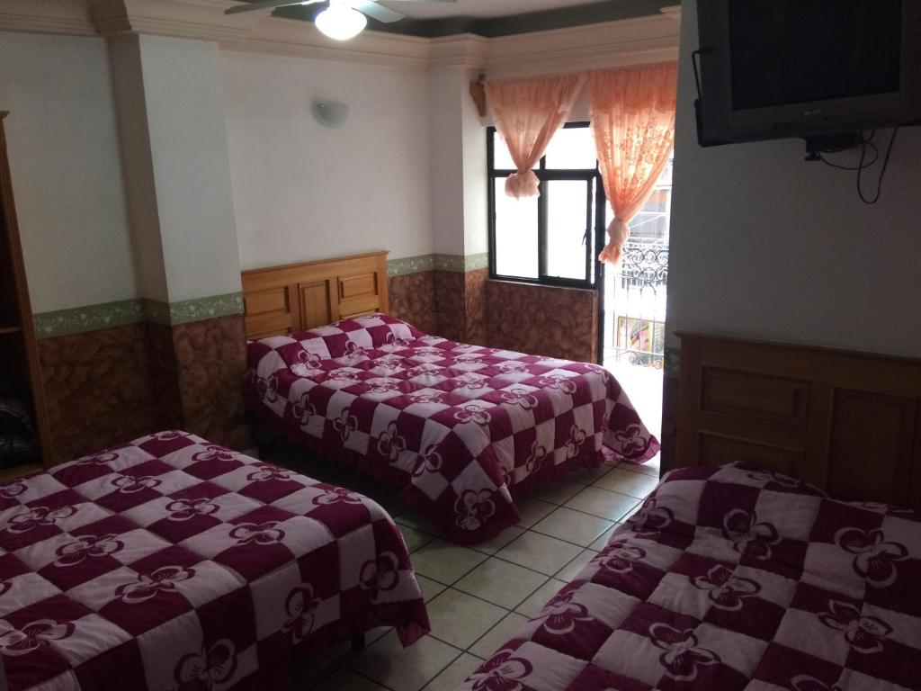 Postel nebo postele na pokoji v ubytování Hotel Senorial