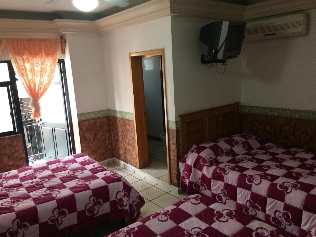 Postel nebo postele na pokoji v ubytování Hotel Senorial