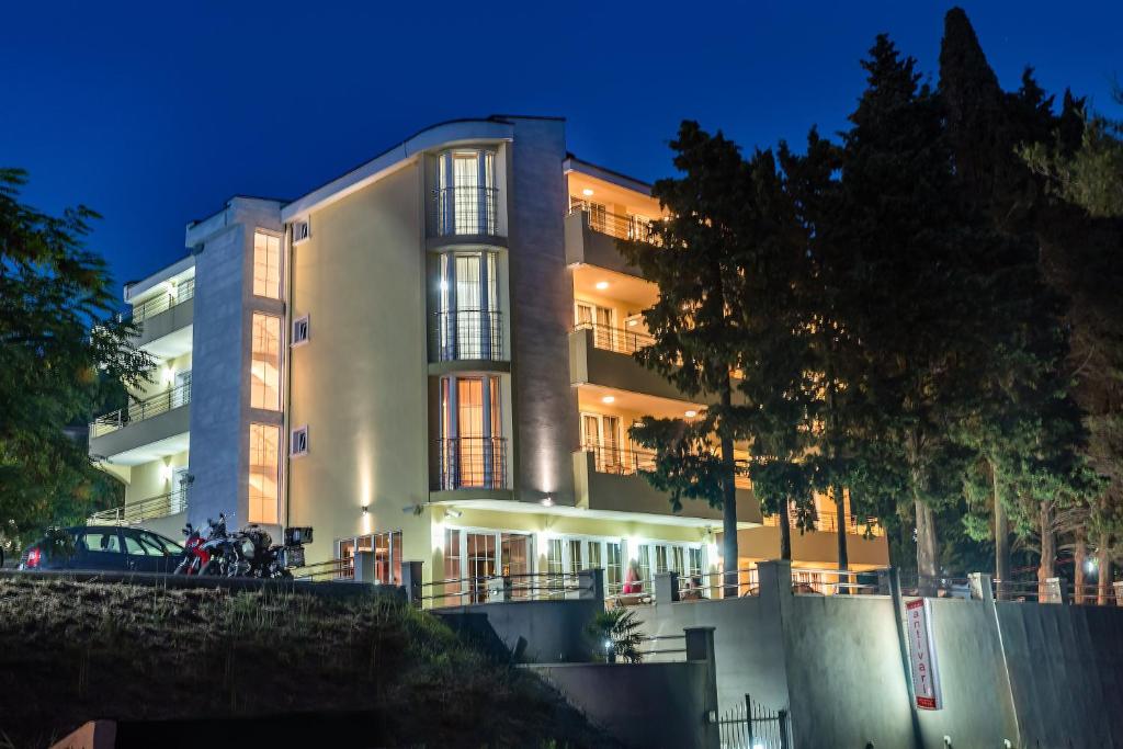 a large building with lights on at night at Villa Antivari in Bar