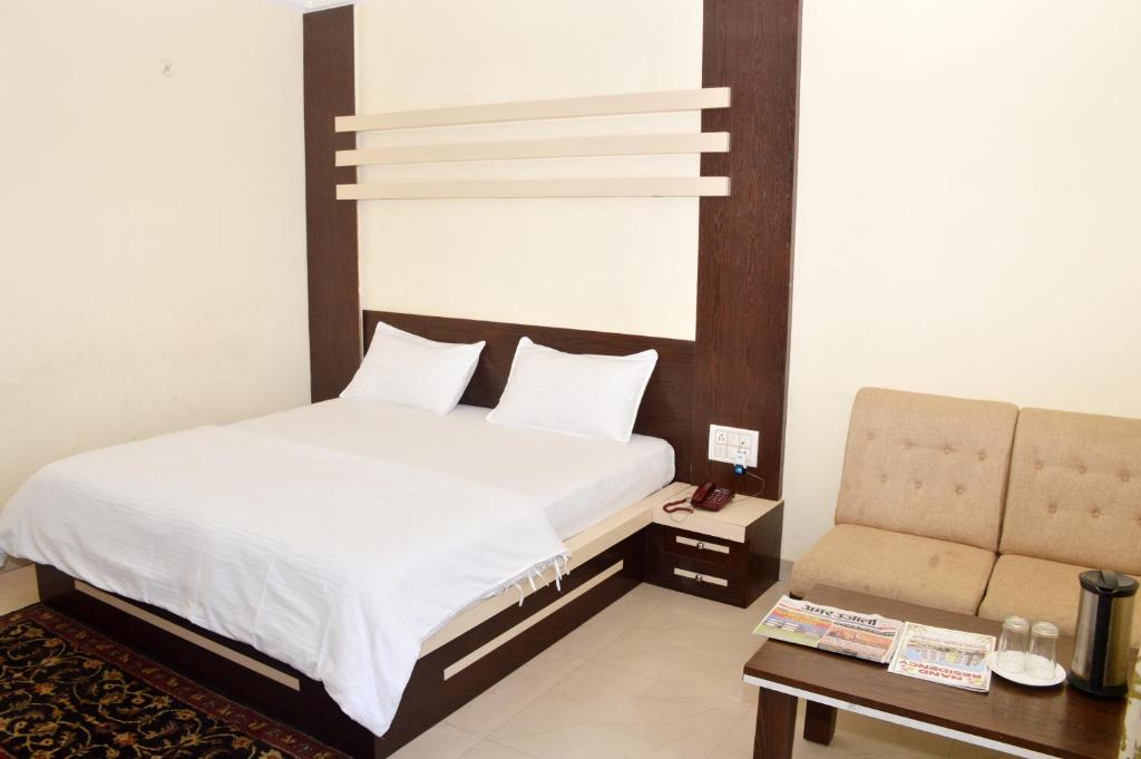 A bed or beds in a room at Hotel Nand Residency