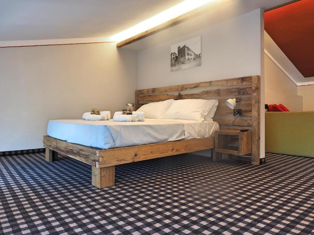 een slaapkamer met een houten bed in een kamer bij Maison de La Lumière in Rivoltella