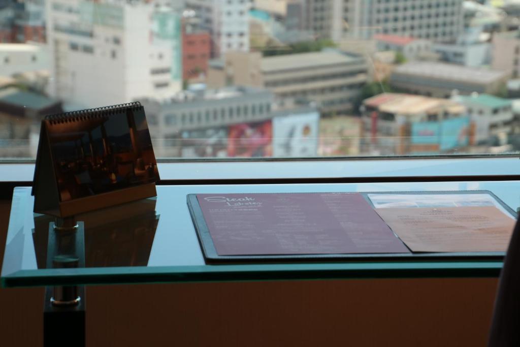 a laptop sitting on a table in front of a window at Shangri-La Far Eastern Tainan in Tainan