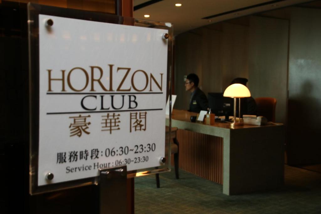 a sign for a horean club in a hotel room at Shangri-La Far Eastern Tainan in Tainan
