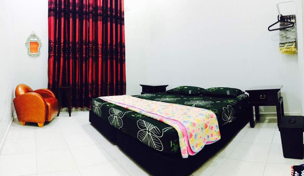 Postel nebo postele na pokoji v ubytování Homestay Melaka Urich