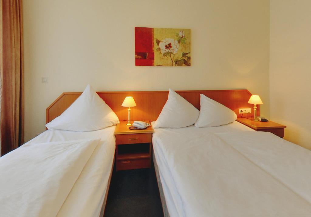 Postel nebo postele na pokoji v ubytování Hotel Terminus am Hauptbahnhof & ZOB