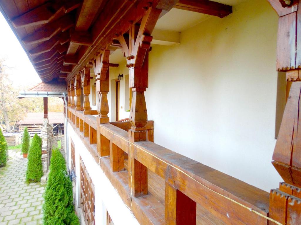 a building with wooden beams on the side of it at Pension Casa Iurca in Sighetu Marmaţiei