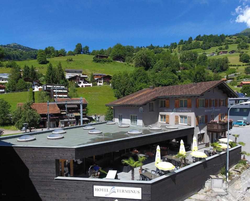 a building with umbrellas and a resort at Hotel Terminus in Küblis