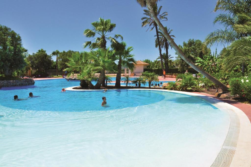 una piscina en un complejo con gente nadando en él en Mazarron Country Club Resort, en Mazarrón
