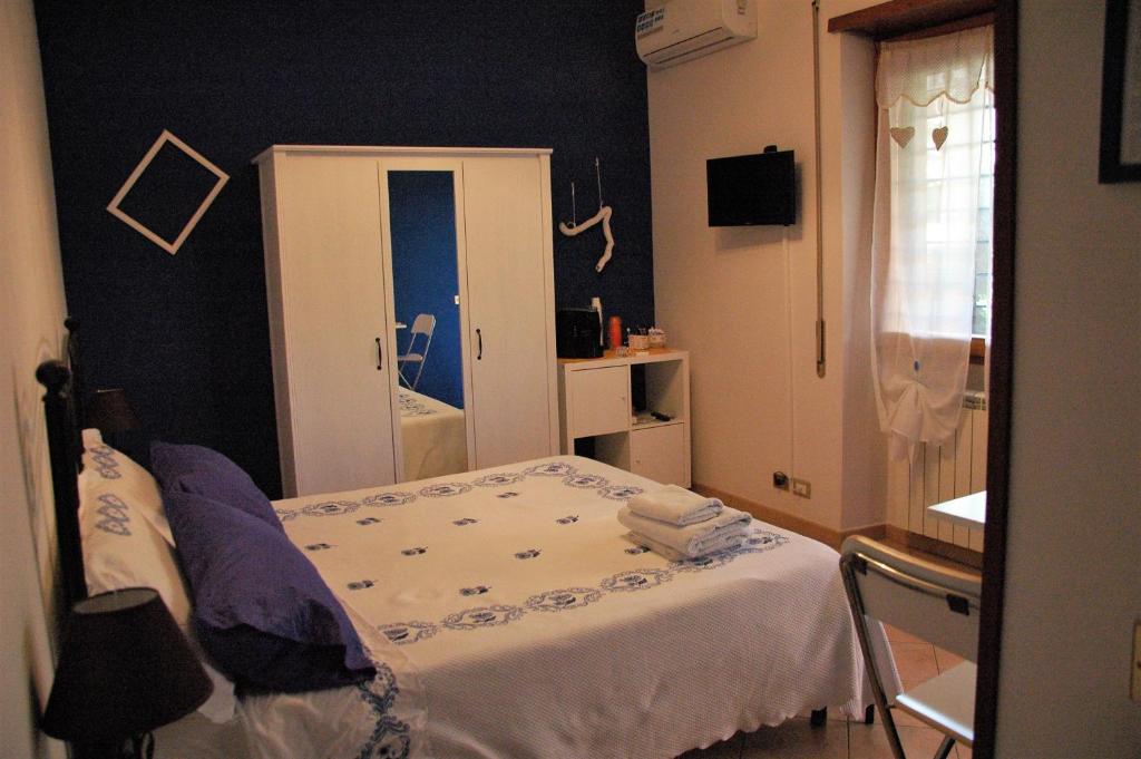 Łóżko lub łóżka w pokoju w obiekcie Le Anfore