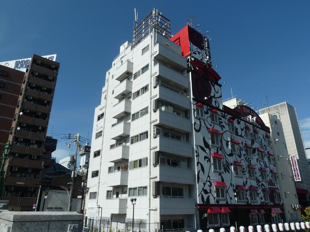 
a large building with a clock on the side of it at GUEST HOUSE B's FiveⅡ in Osaka
