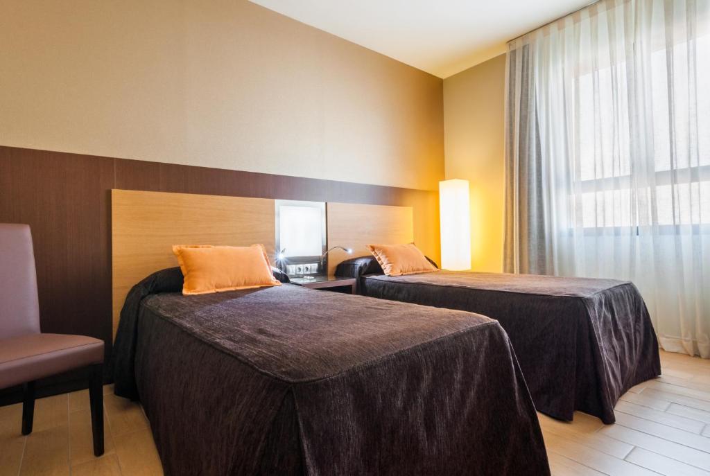 Postel nebo postele na pokoji v ubytování Hotel Ciudad de Alcañiz