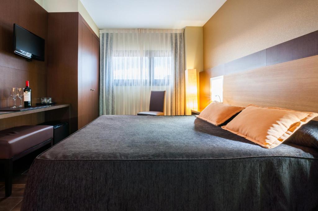 Postel nebo postele na pokoji v ubytování Hotel Ciudad de Alcañiz