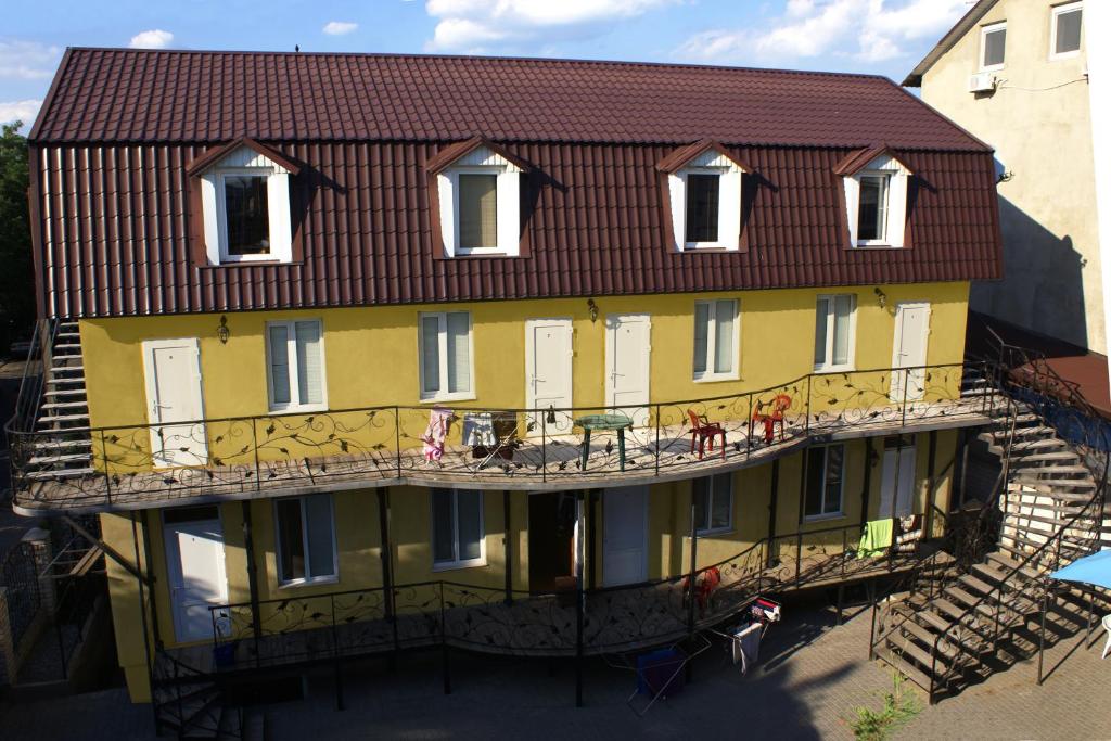 a large yellow building with a red roof at Marinus in Gribovka