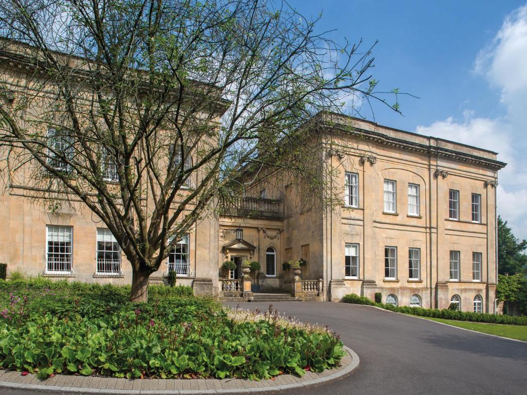 a large building with a tree in front of it at Bailbrook House Hotel, Bath in Bath