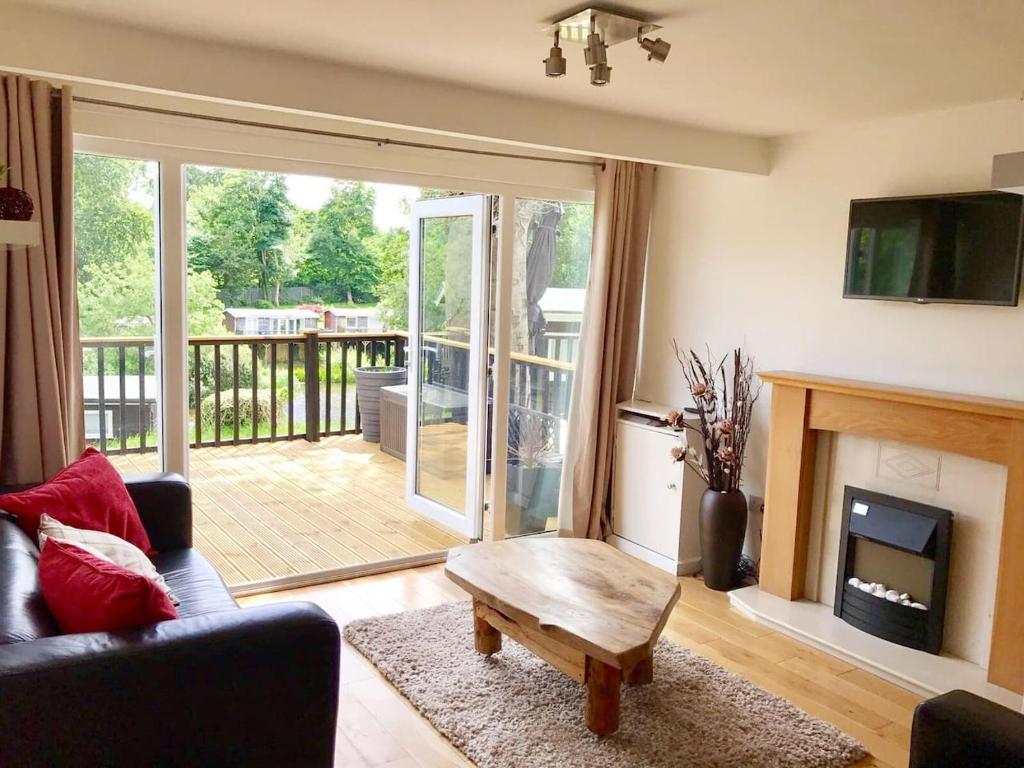 a living room with a couch and a coffee table at North Wales Lake View 2 Bedroom in Caernarfon