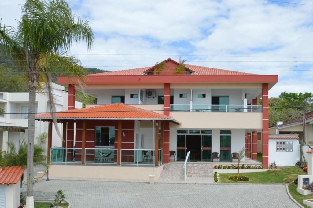 a house with a red roof at Recanto Armação Pousada in Penha