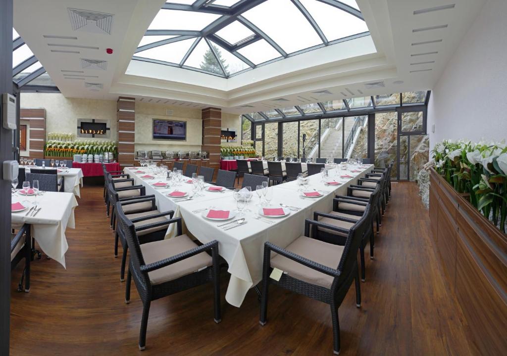 a large dining room with a long table and chairs at Hotel Dvorana in Karlovy Vary
