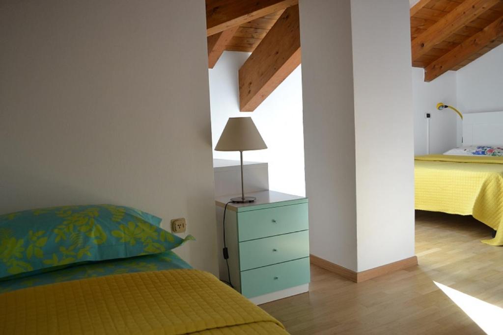 a bedroom with a yellow bed and a blue dresser at Casa River - CIPAT 022006-AT-059712 in Arco