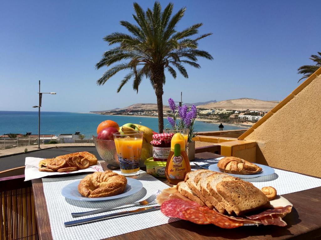 a table with food and a view of the ocean at El Granillo G-96 in Costa Calma