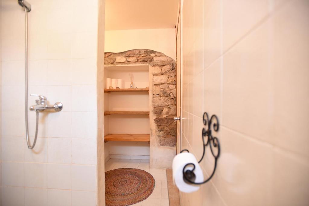a bathroom with a shower with a glass door at Williams House in Eilat