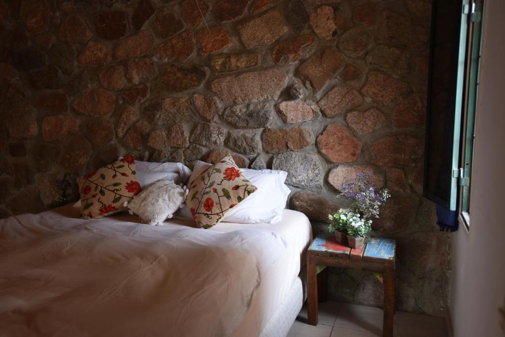 a bed with two stuffed animals sitting on it at Williams House in Eilat