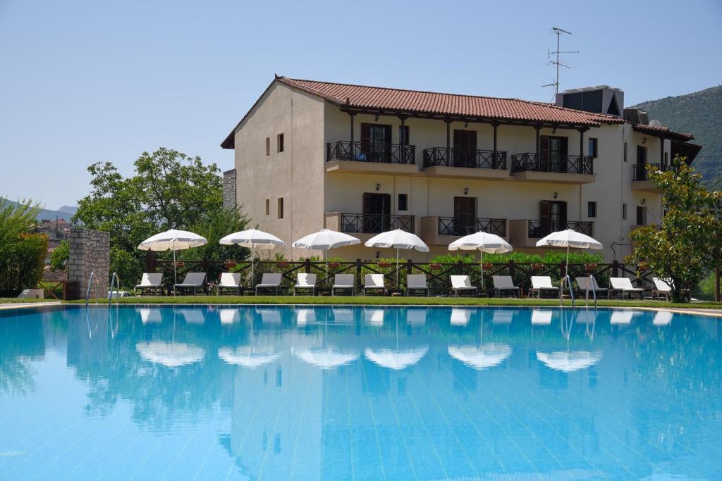 a large swimming pool in front of a building at Mont Helmos Hotel in Klitoria