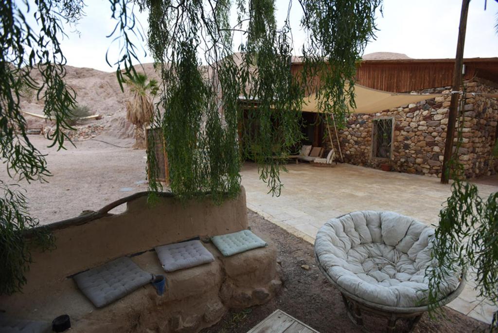 an outdoor patio with a couch and a building at Williams House in Eilat