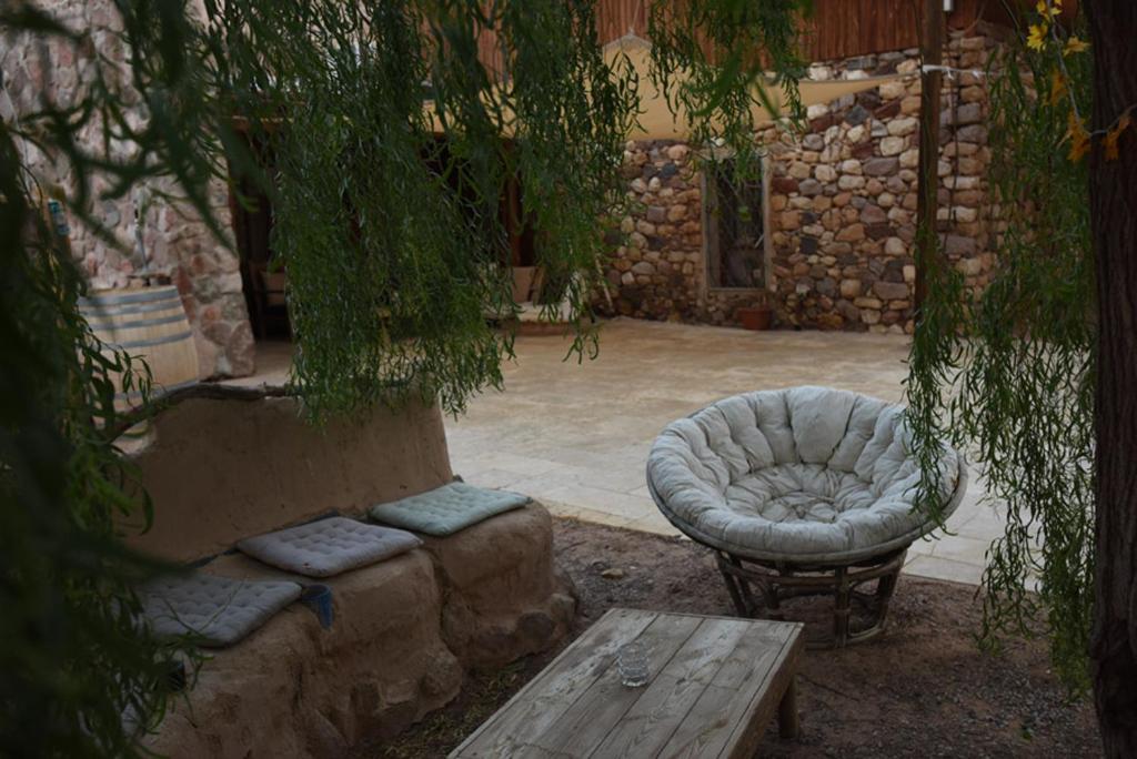 a patio with a couch and a chair and a table at Williams House in Eilat